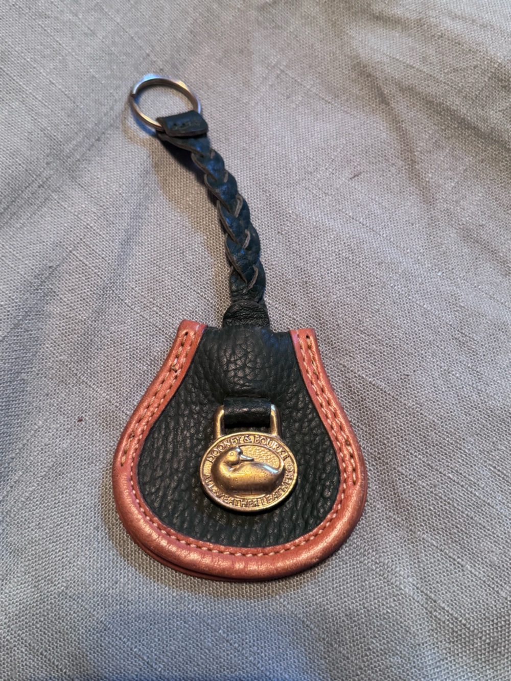 Dooney & Bourke green Leather Braided Strap with Brown Trim and Gold Medallion